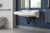 An accessible wall-hung sink with insulated knee-clearance pipes, long lever faucet and generous clear space beneath