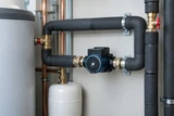 A well-insulated domestic hot-water circulation loop with a compact efficient pump and neatly wrapped pipework