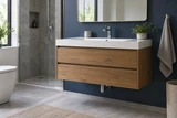A floating wood bathroom vanity with rectangular white basin and two drawers, chrome drain visible beneath