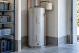 A conventional cylindrical storage water heater with expansion tank and copper pipes in a tidy garage utility alcove