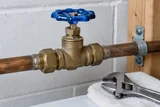 Accessible main water shutoff valve in a household utility area