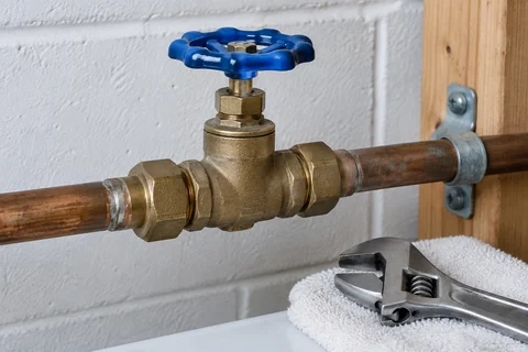Accessible main water shutoff valve in a household utility area